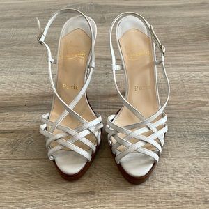 Red bottom Christian Louboutin white platforms.  Killer wedding shoes